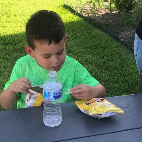 A child enjoying a snack outside at the First Presbyterian Church in Cuero, Texas.